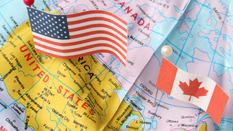 Canada and the US flags on a map.
